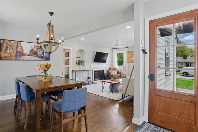 13 Kingston St, North Reading, MA 01864 - dining room featuring dark wood-type flooring, a glass covered fireplace, baseboards, a chandelier, and recessed lighting