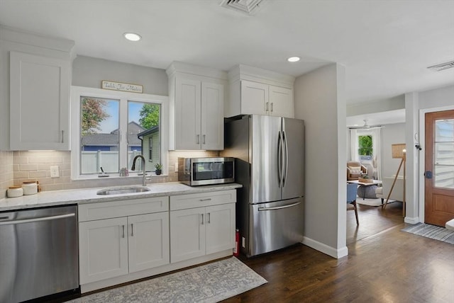 13 Kingston St, North Reading, MA 01864 - kitchen with stainless steel appliances, a sink, plenty of natural light, white cabinets, and recessed lighting