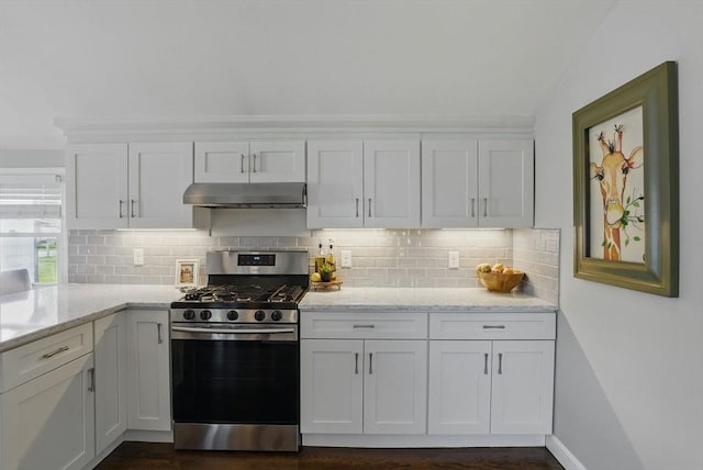 13 Kingston St, North Reading, MA 01864 - kitchen with stainless steel gas stove, under cabinet range hood, white cabinetry, backsplash, and light stone countertops