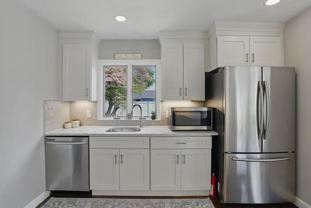 13 Kingston St, North Reading, MA 01864 - kitchen with stainless steel appliances, a sink, white cabinetry, and recessed lighting