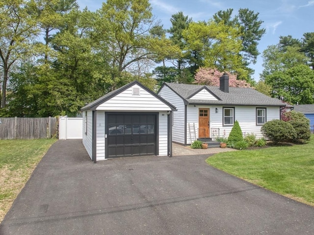 13 Kingston St, North Reading, MA 01864 - view of front of house with a detached garage, a chimney, and an outbuilding
