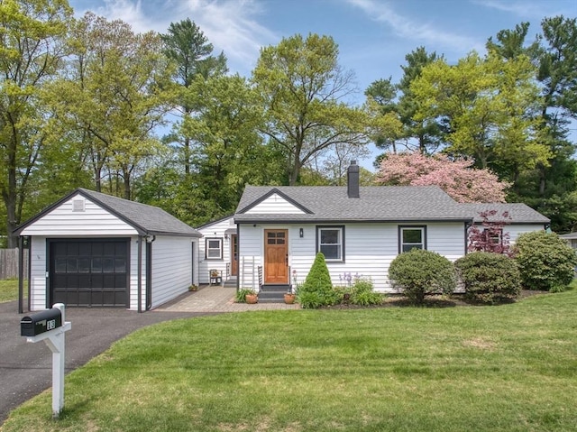 13 Kingston St, North Reading, MA 01864 - view of front of property with a garage, an outdoor structure, a front lawn, and a chimney