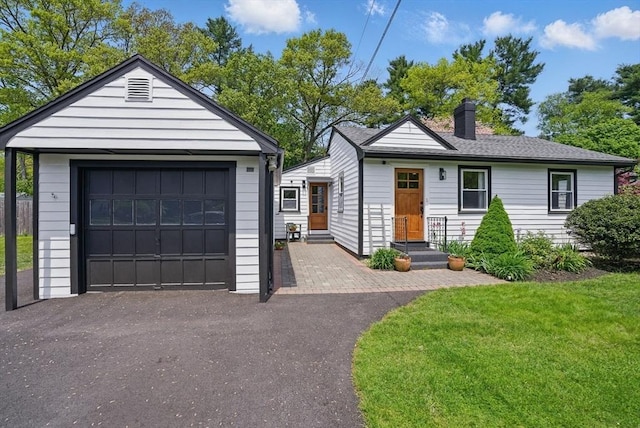 13 Kingston St, North Reading, MA 01864 - view of front of property with a chimney, a detached garage, driveway, an outbuilding, and a front yard