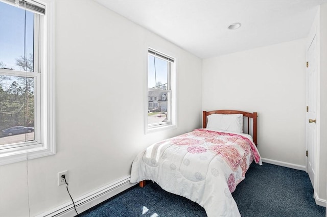 carpeted bedroom with baseboards and a baseboard heating unit