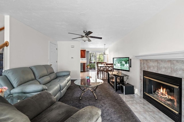 living room featuring ceiling fan and a fireplace