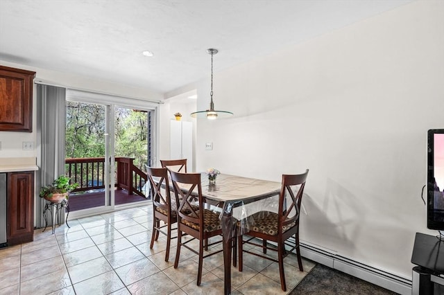 dining space featuring light tile patterned floors and a baseboard heating unit
