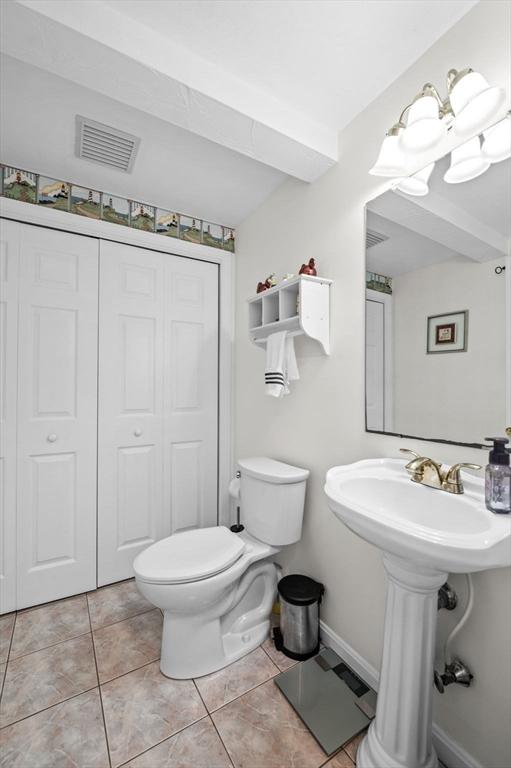 bathroom with visible vents, a closet, toilet, baseboards, and tile patterned floors