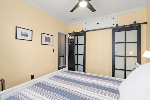 114 Tudor St, Boston, MA 02127 - bedroom featuring a barn door, ornamental molding, and baseboards