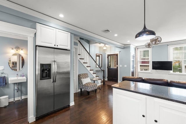 114 Tudor St, Boston, MA 02127 - kitchen featuring stainless steel fridge, dark stone countertops, white cabinets, ornamental molding, and dark wood-style floors