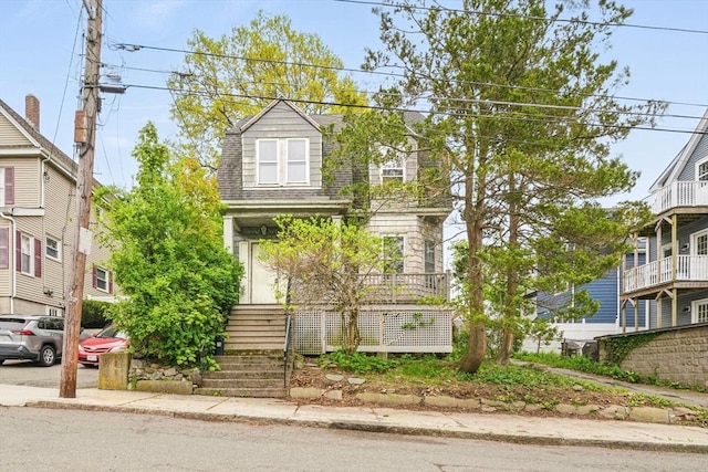 view of front facade with roof with shingles