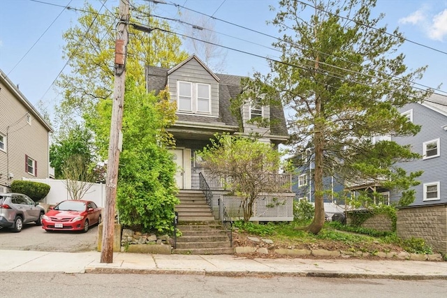 view of front of property featuring roof with shingles