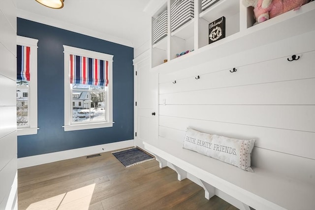 mudroom with crown molding and wood-type flooring