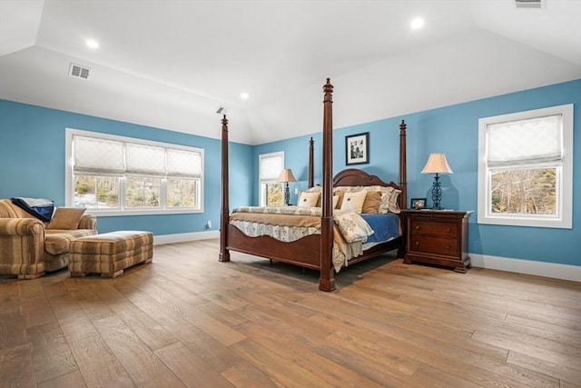 bedroom featuring light hardwood / wood-style floors and lofted ceiling