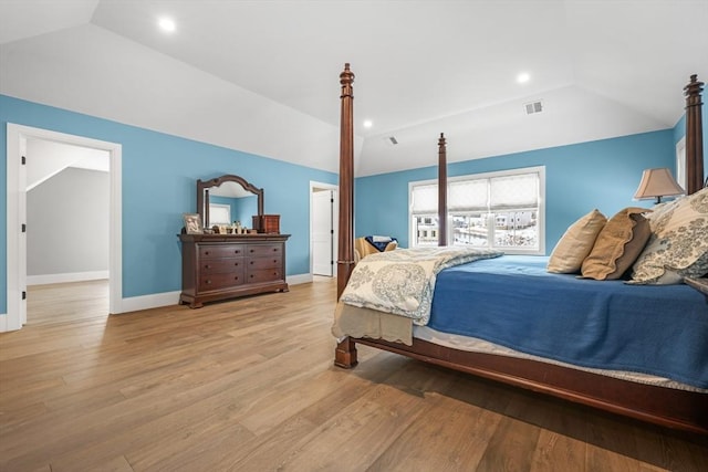 bedroom with lofted ceiling and light hardwood / wood-style flooring