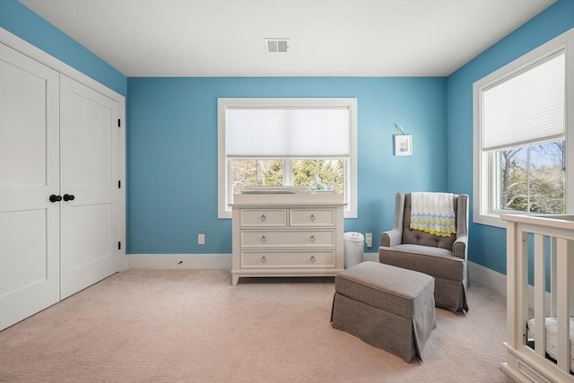 sitting room with light colored carpet and a healthy amount of sunlight