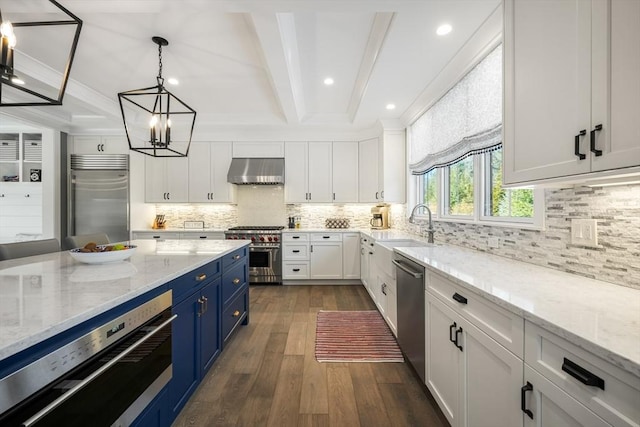 kitchen featuring white cabinetry, high end appliances, and wall chimney range hood