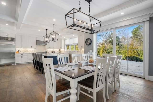 dining room with coffered ceiling, dark hardwood / wood-style floors, an inviting chandelier, and beam ceiling