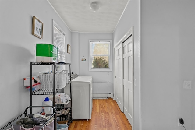 laundry area with washer / clothes dryer, crown molding, and light wood-type flooring