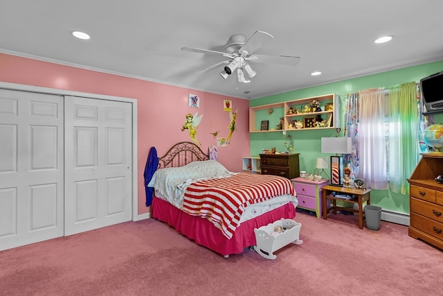 bedroom with crown molding, carpet flooring, ceiling fan, a baseboard radiator, and a closet