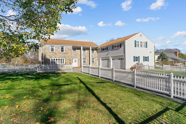 rear view of house with a garage and a lawn