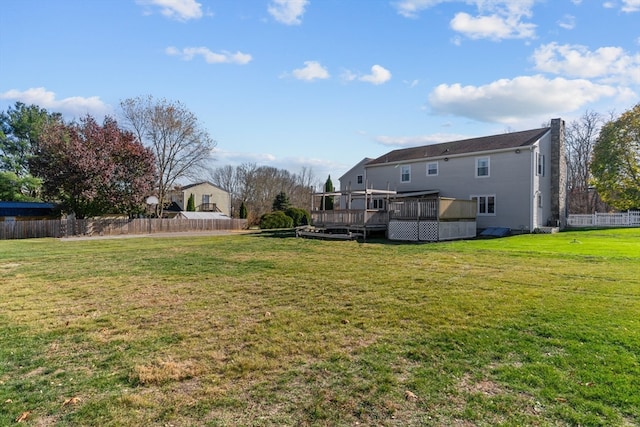 view of yard featuring a sunroom and a wooden deck