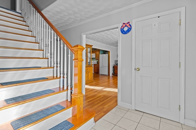 stairway featuring hardwood / wood-style flooring and ornamental molding