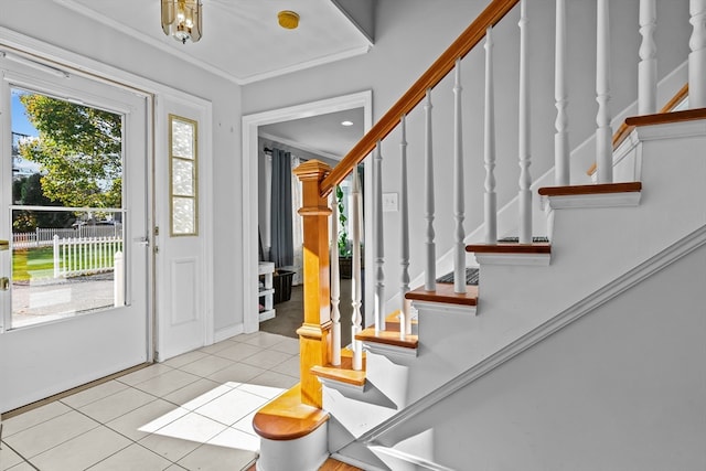 entrance foyer featuring light tile patterned floors and crown molding