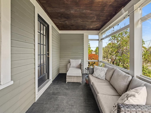 sunroom featuring a healthy amount of sunlight and an outdoor hangout area