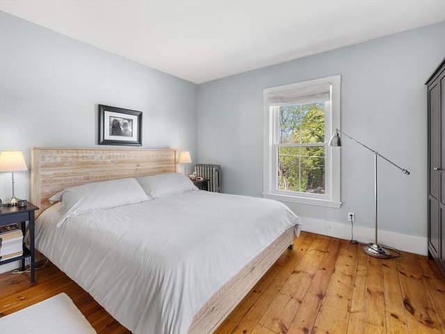 bedroom featuring baseboards and light wood-style flooring