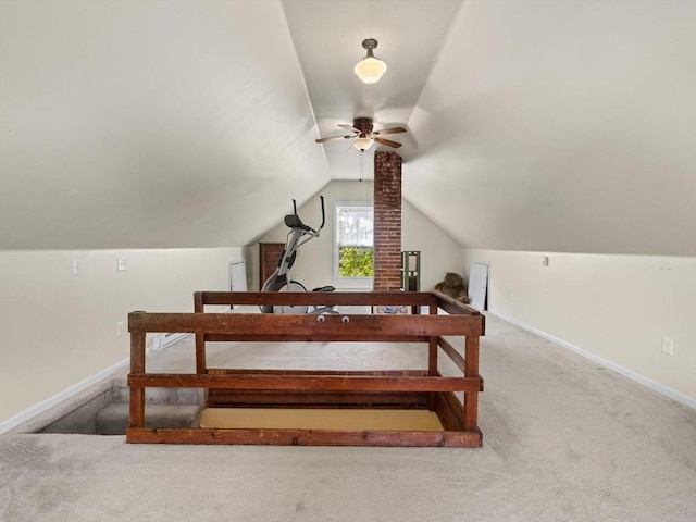 additional living space with carpet floors, a ceiling fan, baseboards, and vaulted ceiling