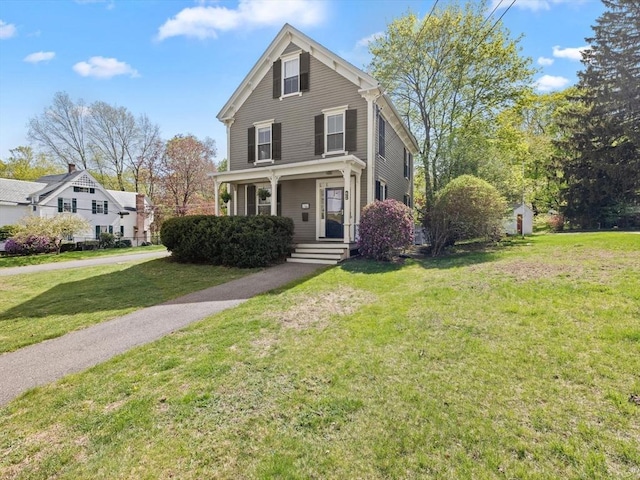 view of front of property with a porch and a front lawn