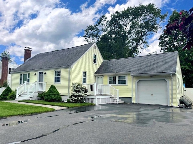 103 Sycamore St, Holbrook, MA 02343 - new england style home featuring a garage, asphalt driveway, a chimney, and a shingled roof