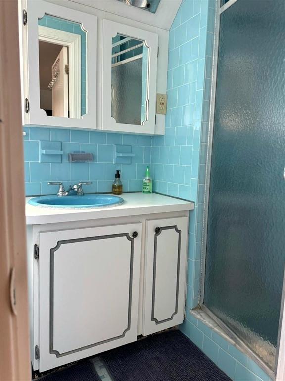 103 Sycamore St, Holbrook, MA 02343 - full bathroom with vanity, a shower stall, and tasteful backsplash
