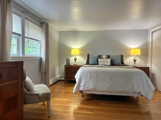 103 Sycamore St, Holbrook, MA 02343 - bedroom featuring a baseboard heating unit and light wood-style flooring