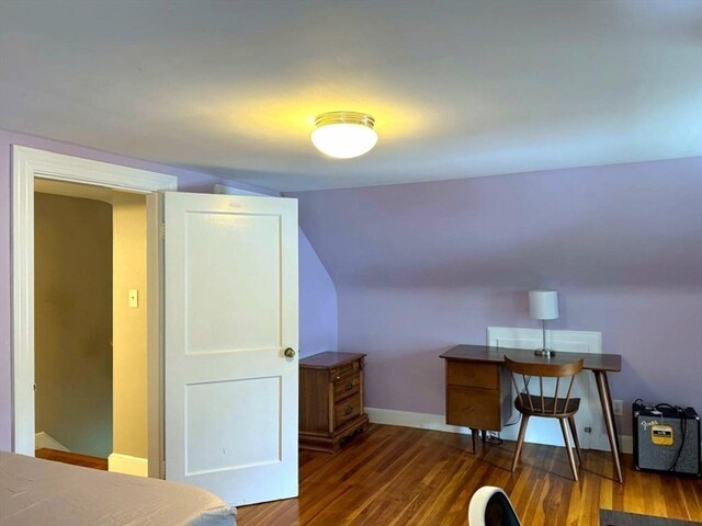 103 Sycamore St, Holbrook, MA 02343 - home office featuring dark wood-style flooring, vaulted ceiling, and baseboards