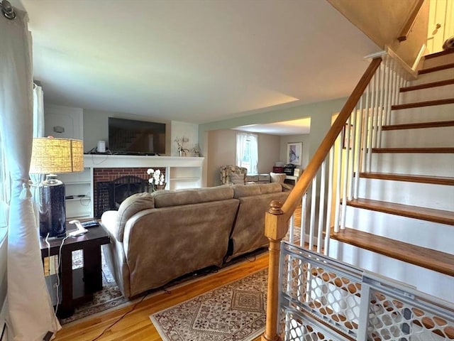103 Sycamore St, Holbrook, MA 02343 - living room featuring wood finished floors, a fireplace, and stairway