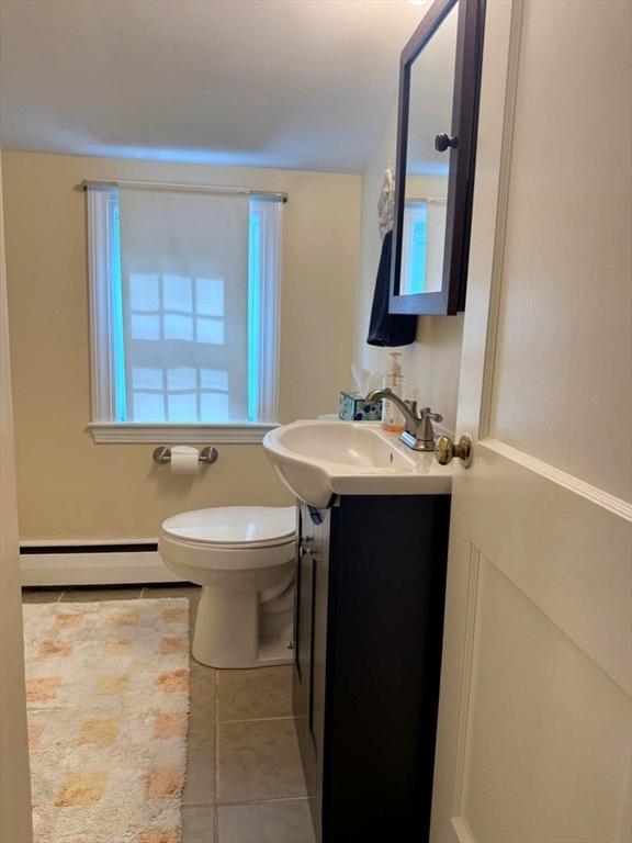 103 Sycamore St, Holbrook, MA 02343 - bathroom featuring a baseboard heating unit, vanity, tile patterned floors, and toilet
