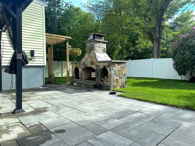 103 Sycamore St, Holbrook, MA 02343 - view of patio featuring an outdoor stone fireplace, a pergola, and view of wooded area