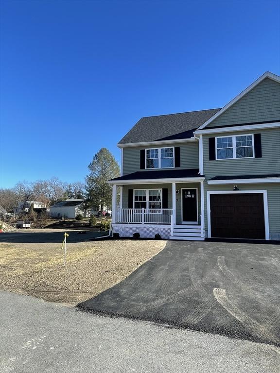 view of front facade featuring aphalt driveway, covered porch, and a garage