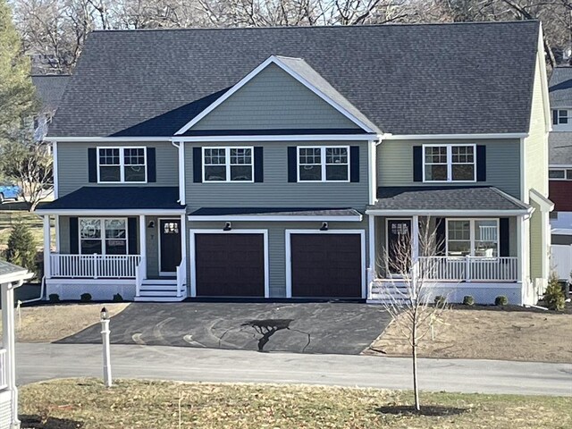 view of front of property with driveway, an attached garage, a porch, and roof with shingles