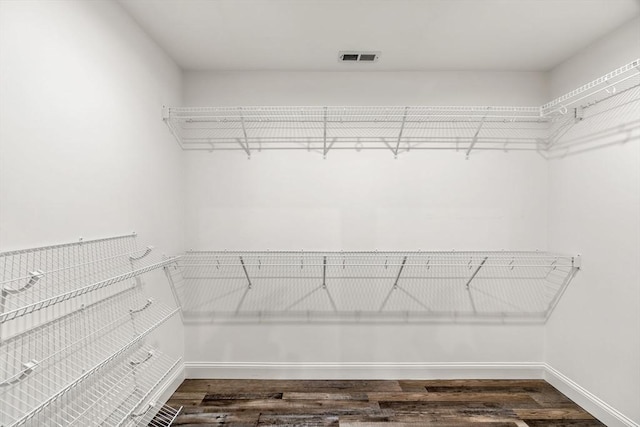 walk in closet featuring visible vents and wood finished floors