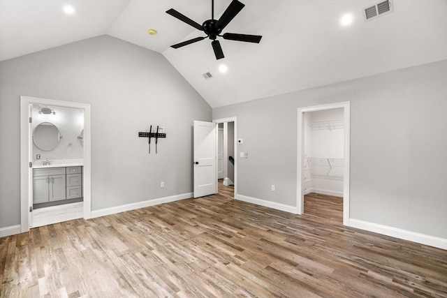 unfurnished bedroom with ensuite bathroom, light wood-style flooring, visible vents, and baseboards