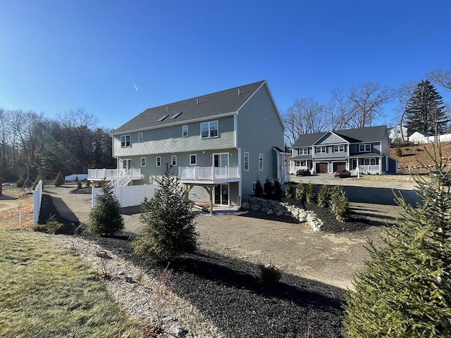 rear view of property with driveway