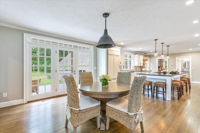 dining area featuring wood finished floors, baseboards, visible vents, and recessed lighting