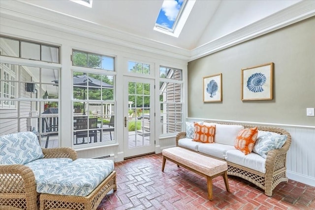 sunroom / solarium featuring french doors, brick floor, vaulted ceiling with skylight, and wainscoting
