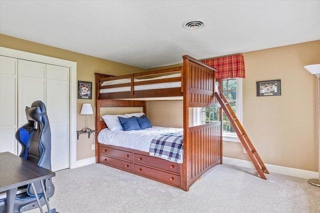 bedroom featuring a closet, visible vents, baseboards, and carpet floors