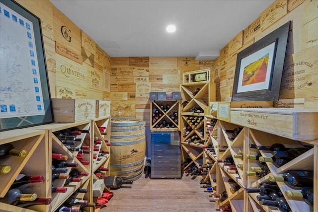 wine room with wood finished floors and wood walls