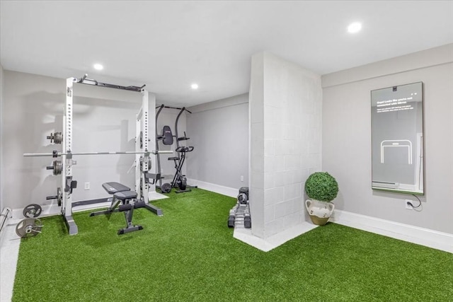 exercise room with baseboards and recessed lighting