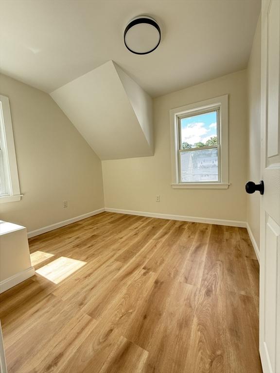 76 Garfield St, Quincy, MA 02169 - additional living space with light wood-type flooring, baseboards, and vaulted ceiling