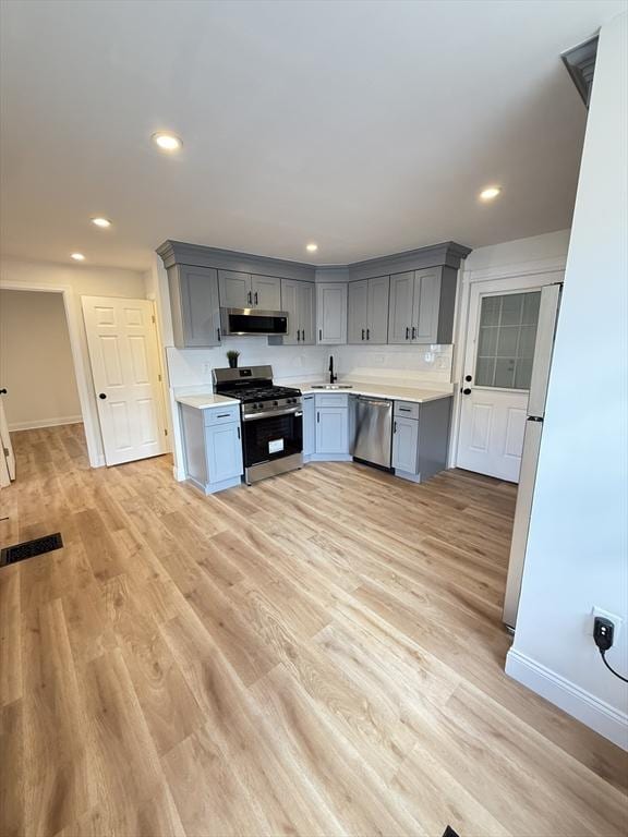 76 Garfield St, Quincy, MA 02169 - kitchen featuring stainless steel appliances, gray cabinets, light countertops, light wood finished floors, and recessed lighting
